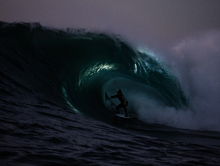Mark Mathews surfs at night by Rodd Owen